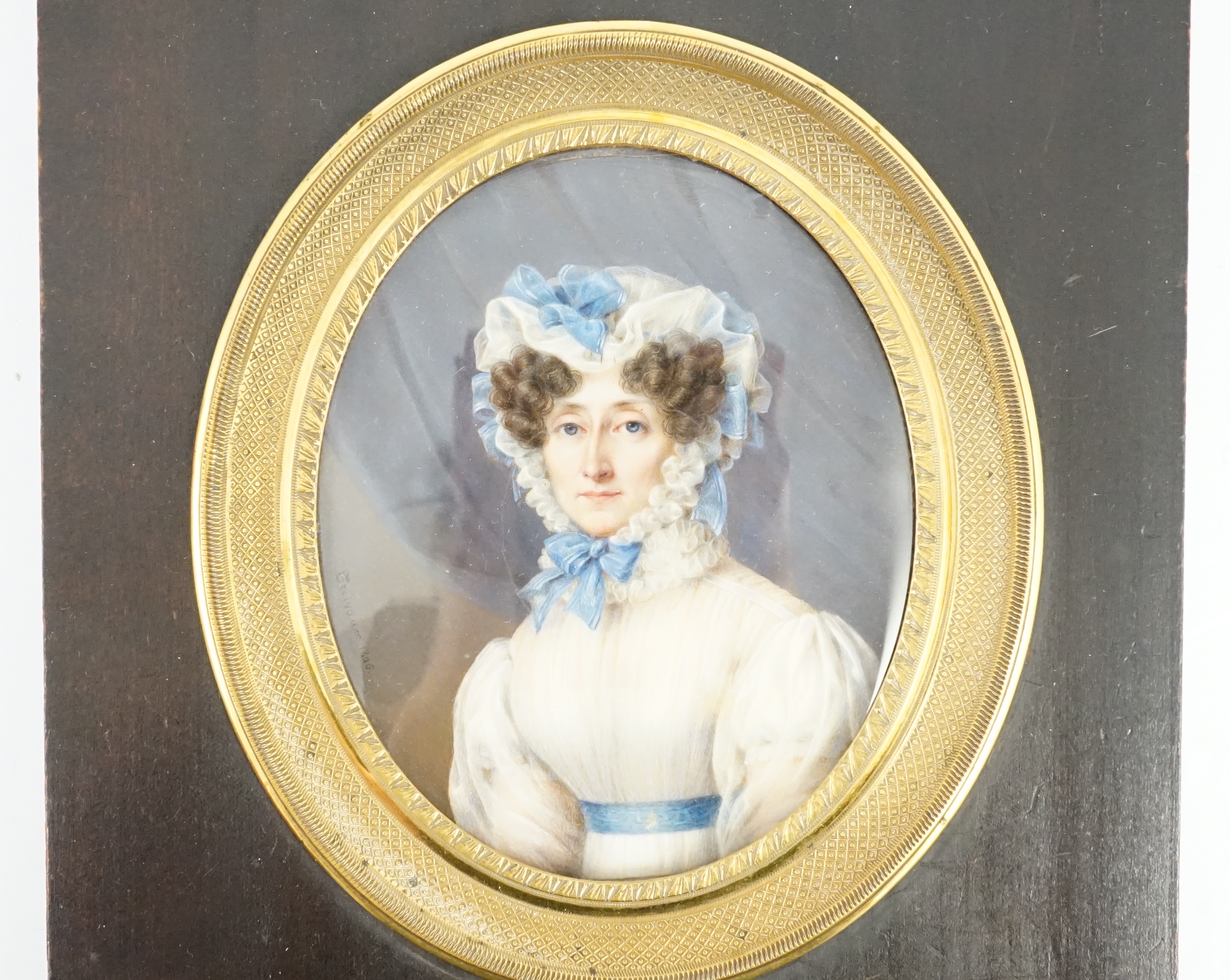 Jean Baptiste Désiré Troivaux (French, 1788-1860), Portrait miniature of a lady, half length, wearing white with a blue sash and blue ribbon-trimmed bonnet, watercolour on ivory, 8.8 x 7.2cm. CITES Submission reference G